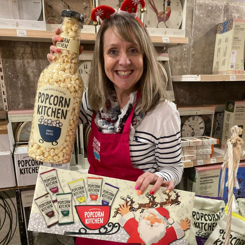 Louise with a giant bottle of popcorn and Christmas popcorn selection box