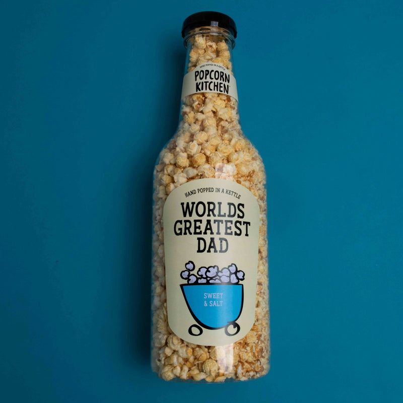 Giant bottle of popcorn with worlds greatest dad label on a blue background