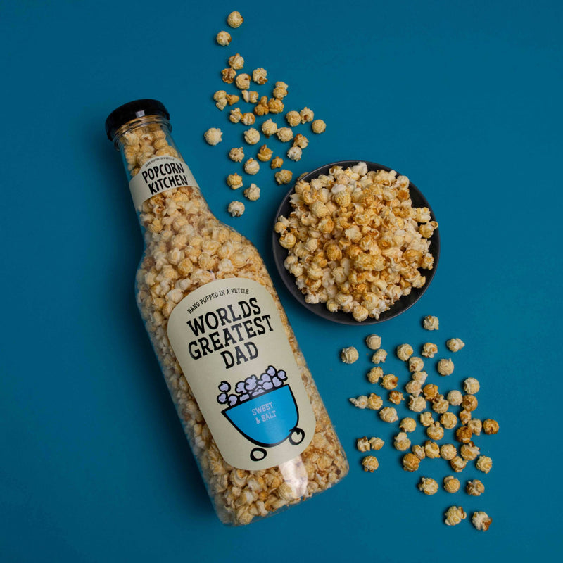 Giant bottle of popcorn with worlds greatest dad label and a bowl of popcorn