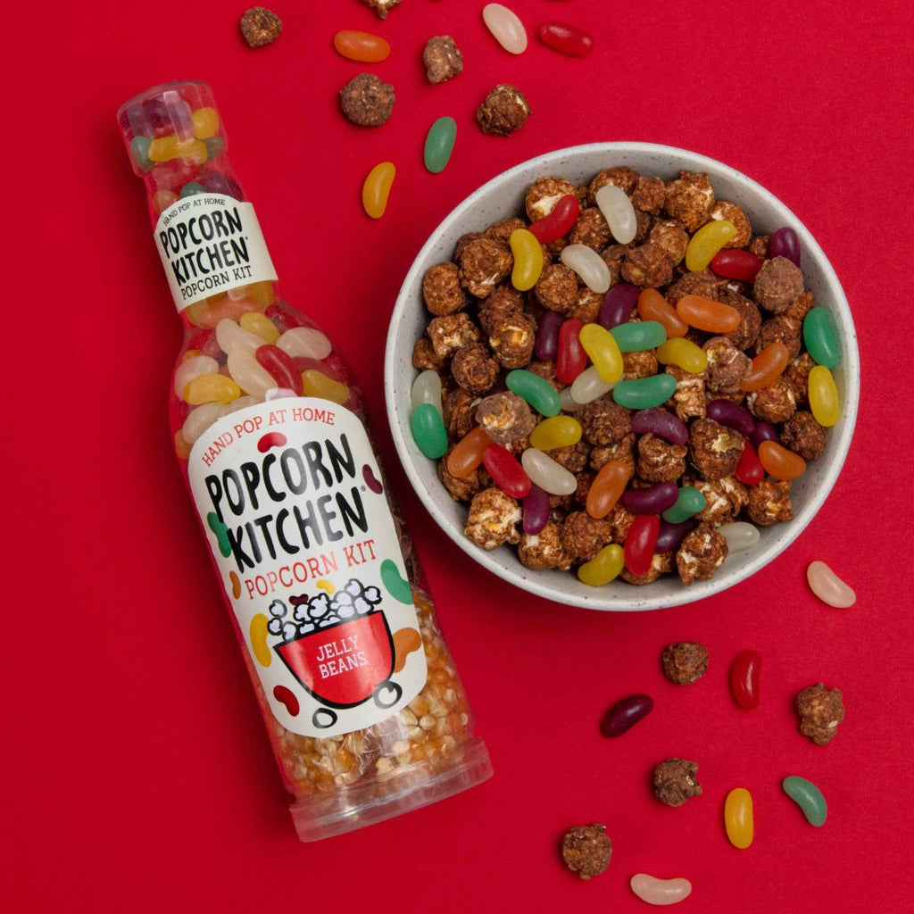 Jellybeans and chocolate popcorn in a bowl with a popcorn kit bottle