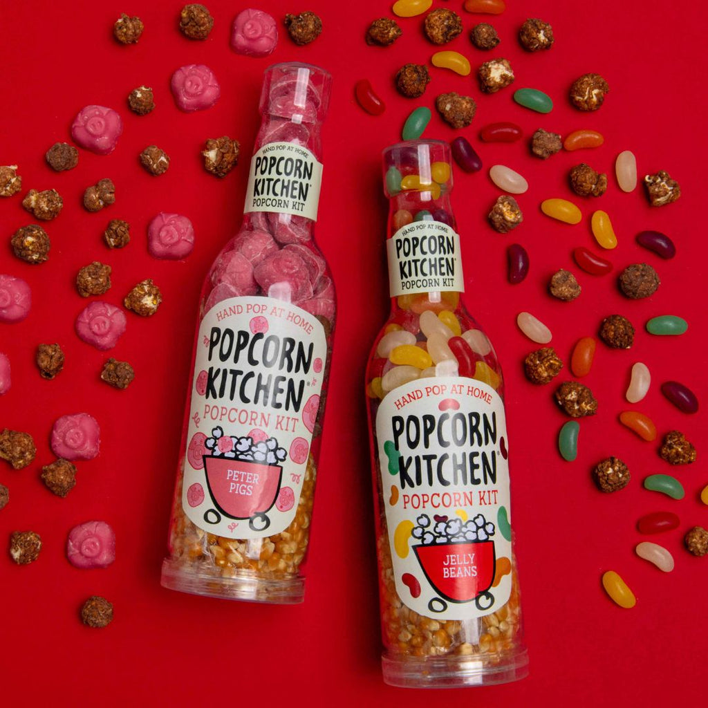 jelly beans and peter pigs pop at home kit bottles with scattered chocolate popcorn and sweets