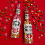 jelly beans and peter pigs pop at home kit bottles with scattered chocolate popcorn and sweets