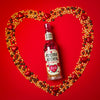 bottle of pop at home chocolate valentines surrounded by a heart made of popcorn kernels, chocolate buttons and red foil wrapped chocolate hearts