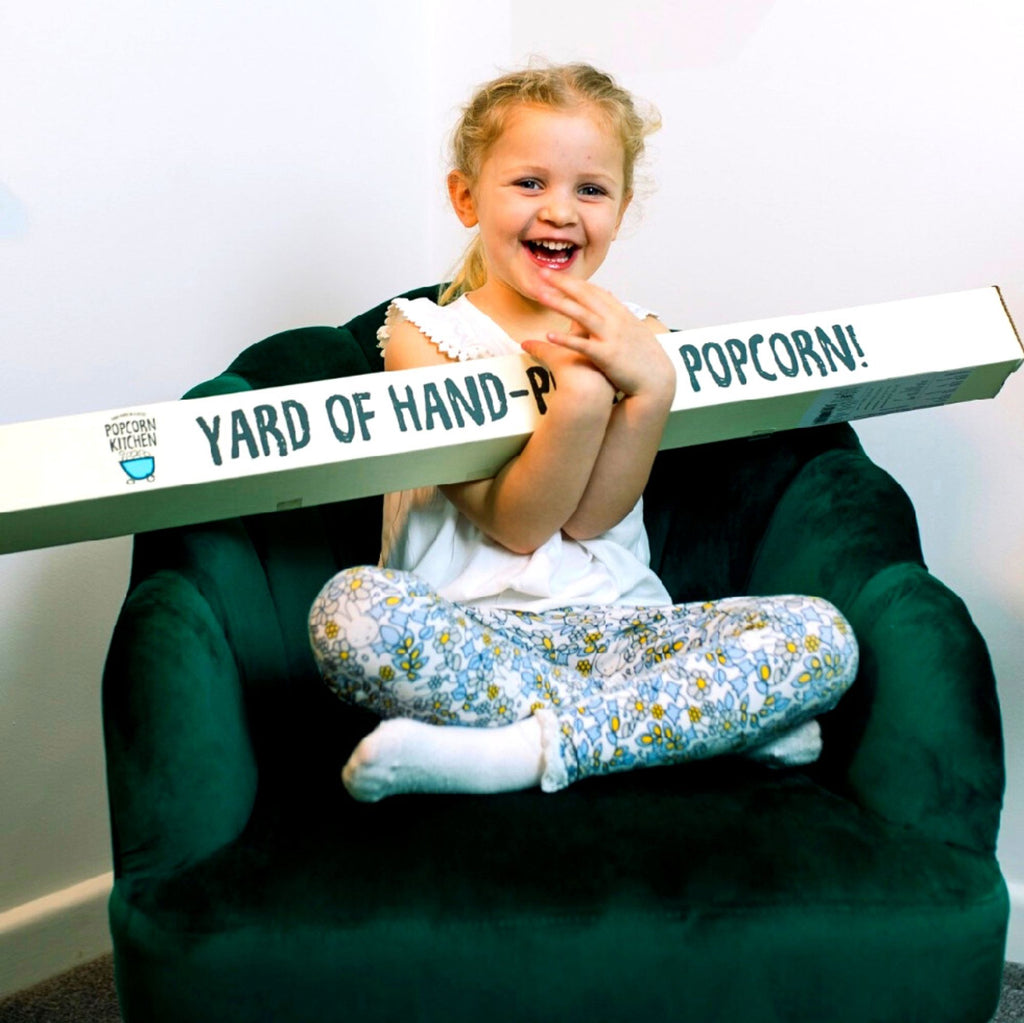 girl-holding-popcorn-kitchen-yard-of-popcorn